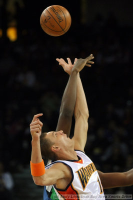Golden State Warriors center Andris Biedrins leaps for the opening tip