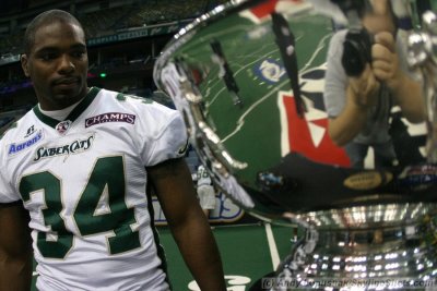 San Jose SaberCats LB Steve Watson looks at the Jim Foster ArenaBowl Trophy