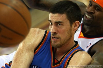 Oklahoma City Thunder's Nick Collison pitches the loose ball away from Golden State Warriors' Stephen Jackson