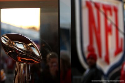 Vince Lombardi Super Bowl Trophy flanked by the NFL logo