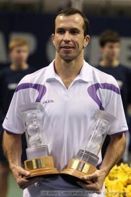 Radek Stepenek holding his singles and doubles trophies from the 2009 SAP Open