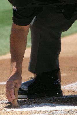 MLB ump cleans home plate