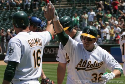 Oakland Athletics DH Jack Cust gets a high-five after hitting a grand slam