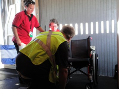Getting ready to transfer into Barb's wheelchair which was brought up from cargo bay of plane.