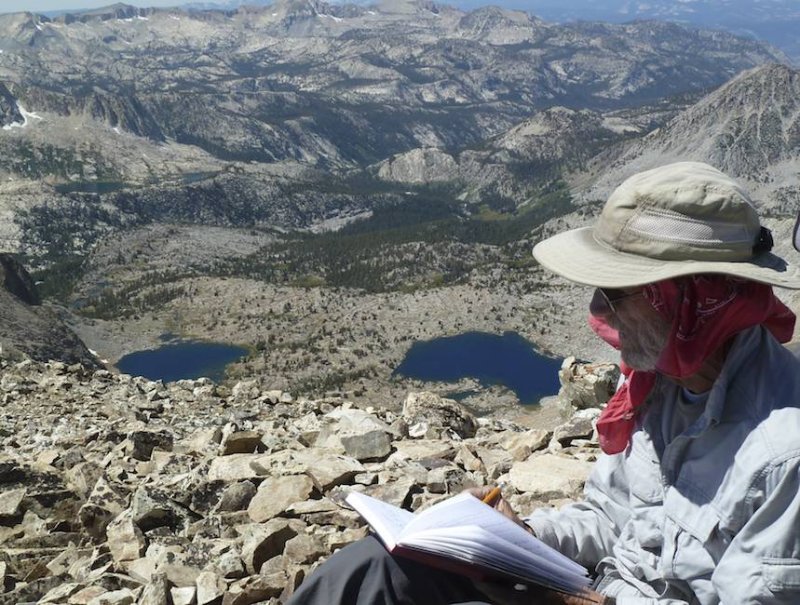 John signs the summit register.