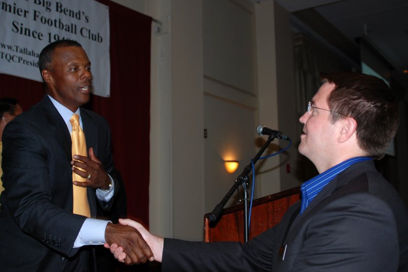 JC Watts signing autographs and shaking hands
