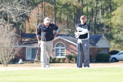 Rodney and John waiting to putt