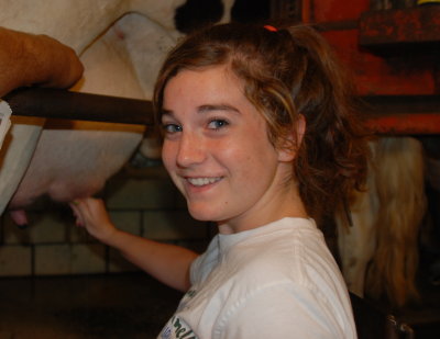 Carlee's turn to milk a cow