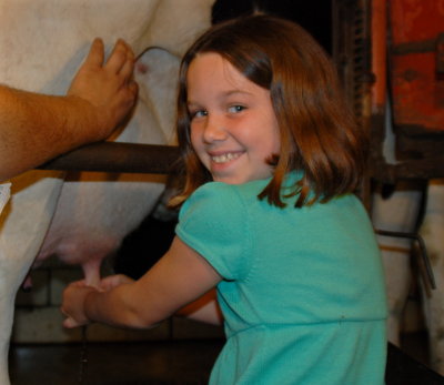 Paige milking a cow