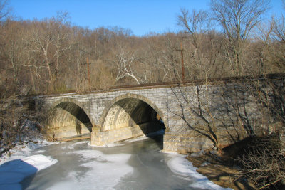 Frozen Catoctin Creek under railroad bridge