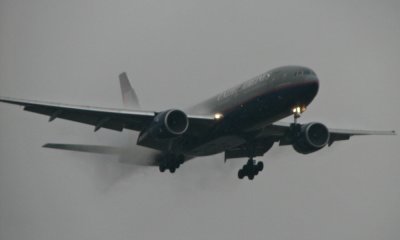 The United 777 blasts through low clouds