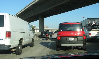 Two-wheeler negotiates LA highway traffic