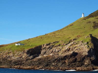 Lighthouse and building near tip of bay