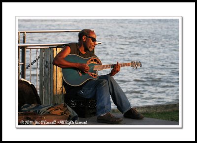 Street Musician Singing Along the Mississippi River