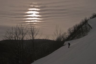 Snowboarding under a rippled sky
