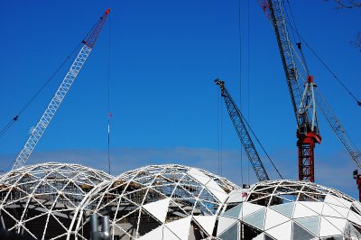 Cranes above Melbourne Rectangular Stadium constructing the bubble dome.