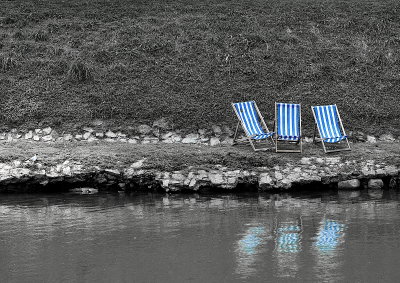 Three empty Chairs along the River