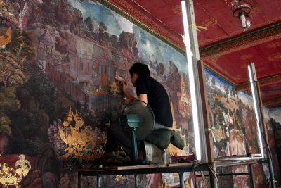 Touching up the 178 murals that depict the Indian epic of Ramakien