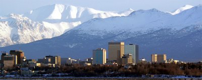 ANCHORAGE BY DAY WITH THE MIGHTY ALASKA COASTAL RANGE IN THE BACKGROUND