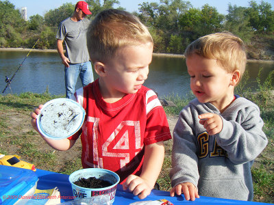 My brother and his friend on a camping trip.  I don't know what is in the bowl but I am staying away from it.