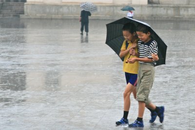 Taking Cover from the Rain at Kim Il Sung Square, P'yongyang