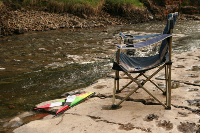 Abandoned deckchair and kite
