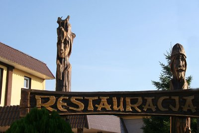 Wooden sculptures near entrance into Praslowianska Restaurant