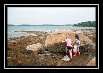 Emmy, Miranda, and Norah considering the boulder