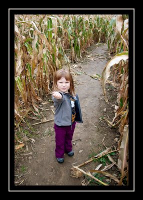 Showing off corn she picked up