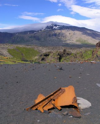 rusted metal with Snaefell in the background covered in clouds