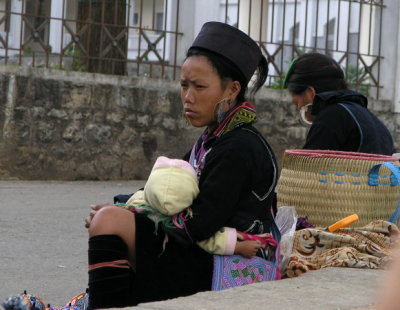 H'Mong woman resting with baby