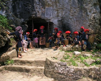 women of the Red Dao tribe at a cave entrance
