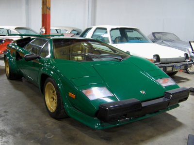 1987 Lamborghini Countach in an unusual green with gold leather interior (yes, it is parked alongside a 1977 AMC Pacer!)