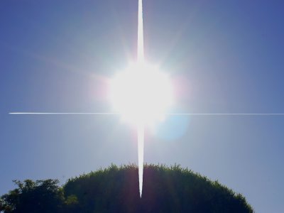 Contrail intersecting sun's rays near Coit Tower