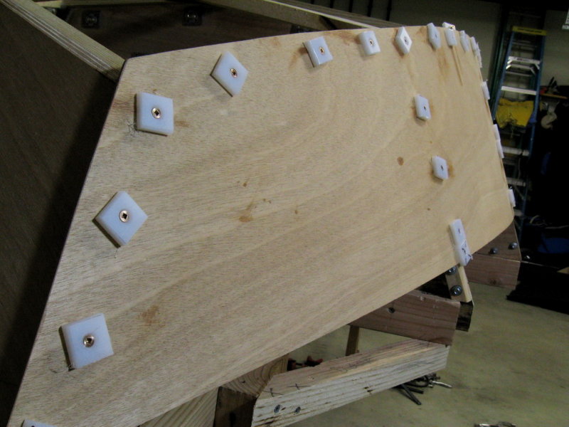 Bronze screws through plastic medallions.  Four mm okume too thin for proper screw installation.