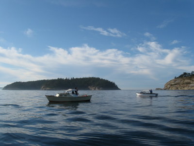 Strait Shot and Stan Johnson's Calkins skiff pause off Matia.