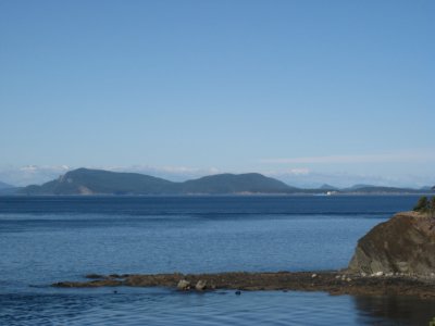 Blue hulled freighter southbound off Saturna, barely visible in the distance.