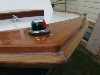 Closeup of bow light and bow chock. Sheer guard will get white paint; toe rail, bright.
