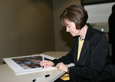 Nancy signs the photo