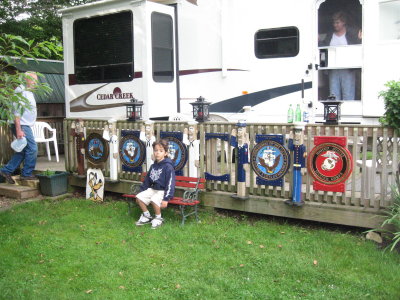 Cooper in front of Grampas service plaques for all our family members, hand painted by Grampa