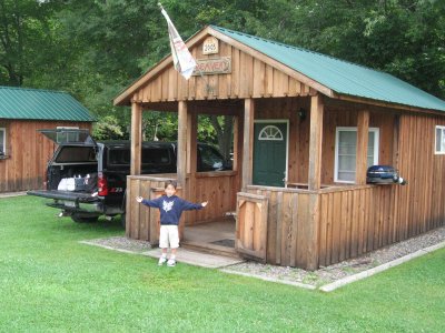 Cooper showing the cabin built by Grampa