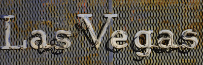 Las Vegas neon sign with steel screen background.