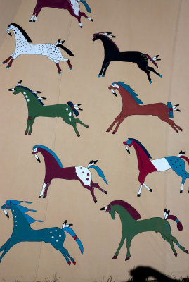 Horses painted on a teepee wall.