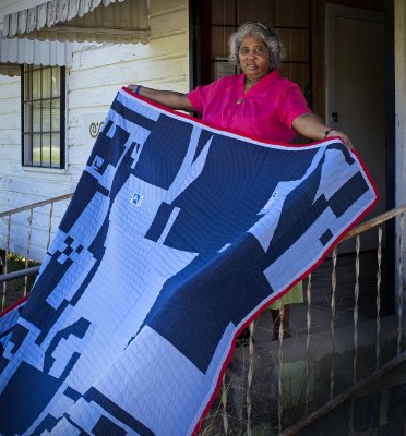 Mary Ann Pettway with quilt made of US Postal Service uniforms, Gee's Bend, AL.