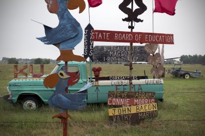 Signs about FEMA, the Kansas State Board of Education, and various subjects.