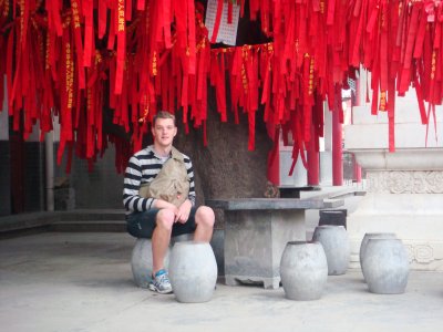 Sammy with prayer flags at the Emperor's Temble on Emperor's Mountain