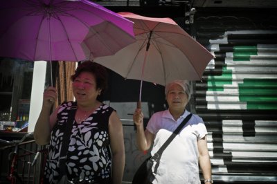 Two Ladies With Umbrellas