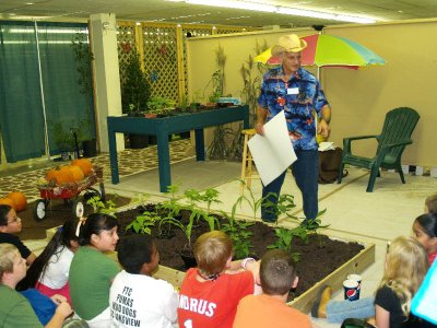 Harvey tells the kids about the garden.