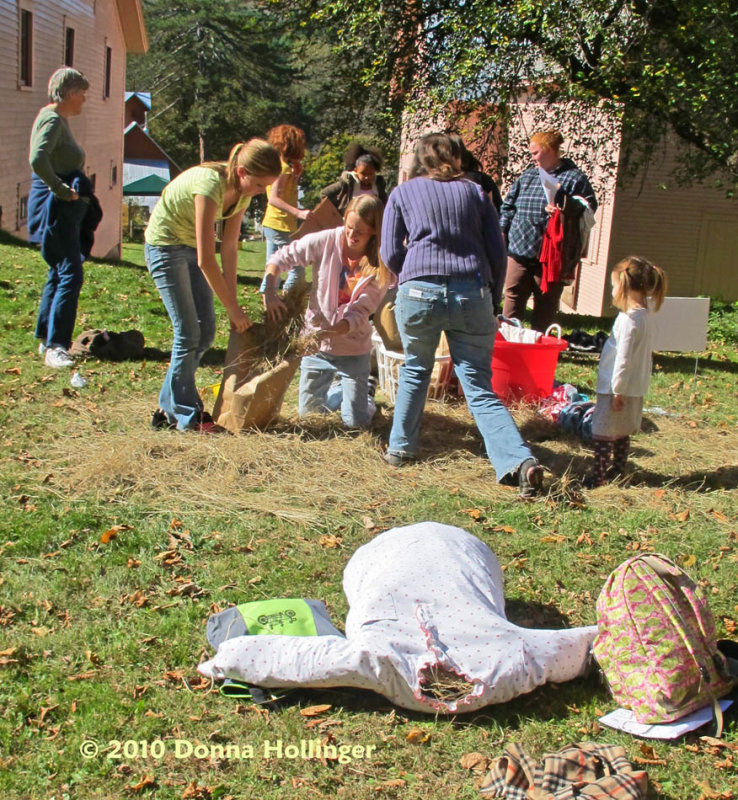 Parents and kids at the Scarecrow Making Area