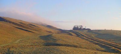 Early sunlight highlights the Vallum,by Cawfields Crags.